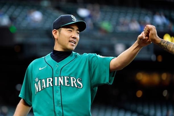 Yusei Kikuchi of the Seattle Mariners gives a fist bump during the game against the Tampa Bay Rays at T-Mobile Park on June 18, 2021 in Seattle,...