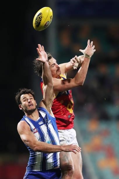 Joe Daniher of the Lions is challenged by Robbie Tarrant of the Kangaroos during the round 14 AFL match between the North Melbourne Kangaroos and the...