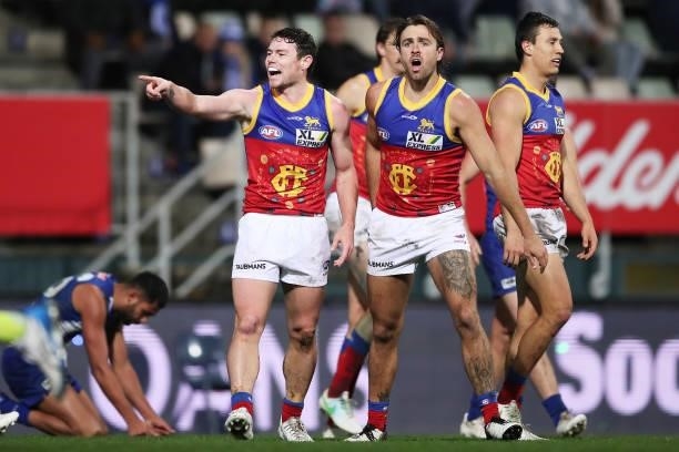 Lachie Neale of the Lions celebrates with team mates after kicking a goal during the round 14 AFL match between the North Melbourne Kangaroos and the...
