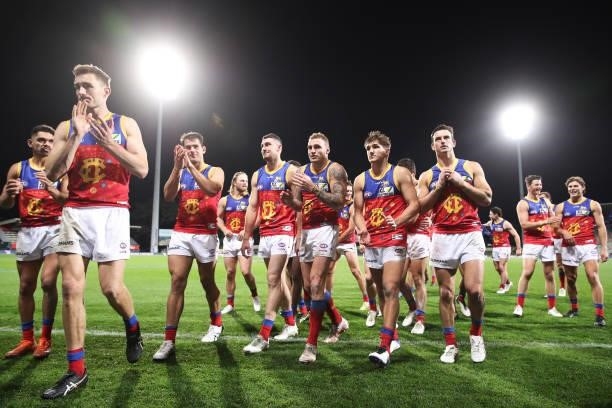 Lions players celebrate victory after the round 14 AFL match between the North Melbourne Kangaroos and the Brisbane Lions at Blundstone Arena on June...