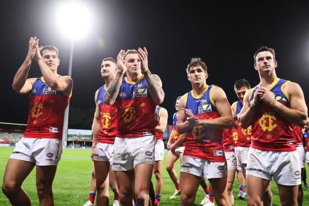 Mitch Robinson of the Lions celebrates victory with team mates after the round 14 AFL match between the North Melbourne Kangaroos and the Brisbane...
