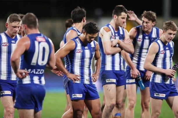 Kangaroos players look dejected after the round 14 AFL match between the North Melbourne Kangaroos and the Brisbane Lions at Blundstone Arena on June...