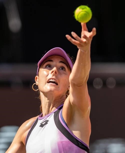 Alize Cornet of France serves against Belinda Bencic of Switzerland in the women's singles semifinal match during day 8 of the bett1open at LTTC...
