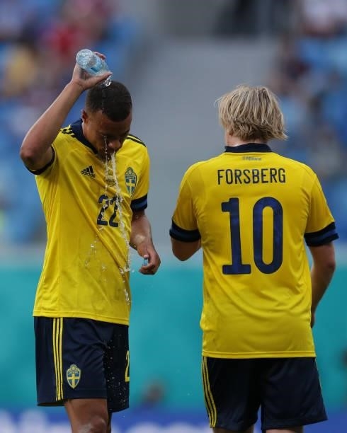 Robin Quaison of Sweden pours water over his head ahead of his teammate Emil Forsberg during the UEFA Euro 2020 Championship Group E match between...