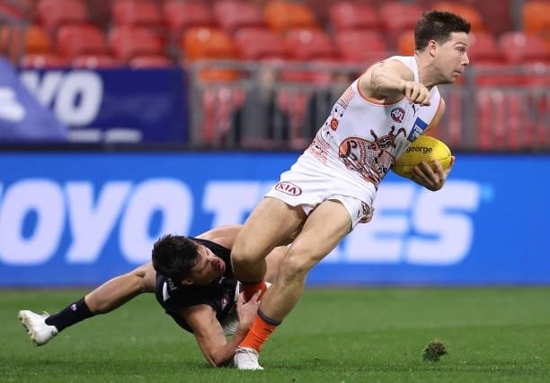 Toby Greene of the Giants is tackled by Nic Newman of the Blues during the round 14 AFL match between the Greater Western Sydney Giants and the...