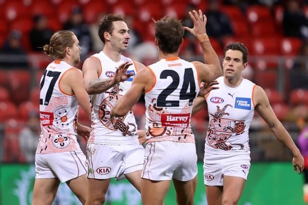 Jeremy Finlayson of the Giants is congratulated by team mates after kicking a goal during the round 14 AFL match between the Greater Western Sydney...