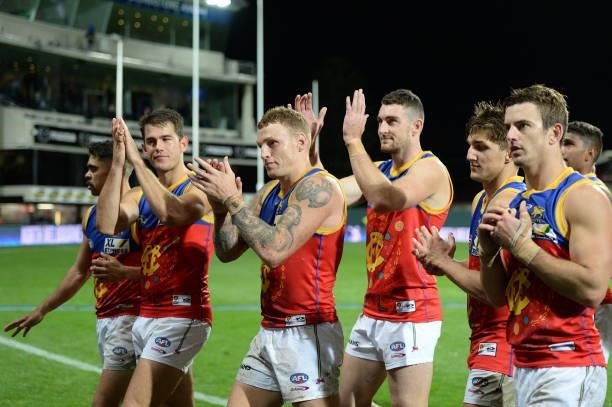 Lions players leave the field after the game during the round 14 AFL match between the North Melbourne Kangaroos and the Brisbane Lions at Blundstone...