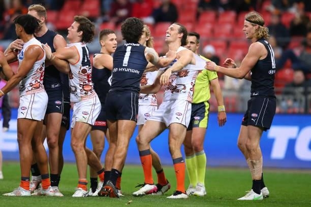 Jack Silvagni of the Blues scuffles with Phil Davis of the Giants during the round 14 AFL match between the Greater Western Sydney Giants and the...