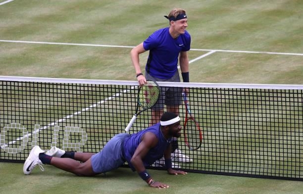 Frances Tiafoe of USA slips during his Quarter-final match and is assisted by Denis Shapovalov of Canada during Day 6 of The cinch Championships at...