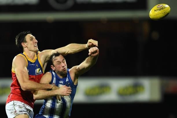 Todd Goldstein of the Kangaroos and Oscar McInerney of the Lions compete in a ruck contest during the round 14 AFL match between the North Melbourne...