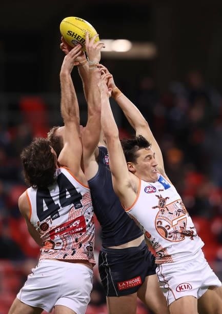 Harry McKay of the Blues marks infront of Jack Buckley and Isaac Cumming of the Giants during the round 14 AFL match between the Greater Western...