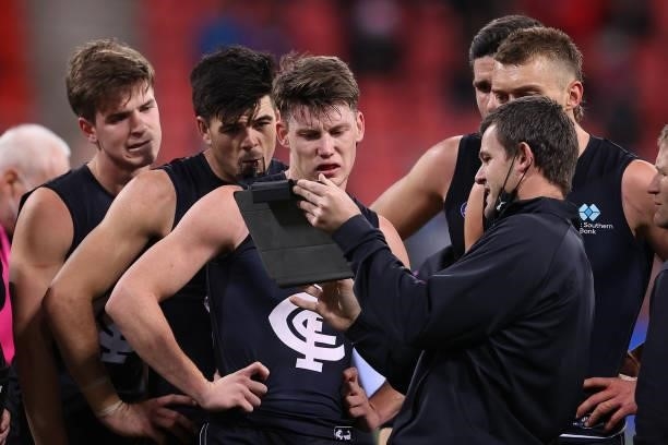 Blues assistant coach Brent Stanton talks to his players during the round 14 AFL match between the Greater Western Sydney Giants and the Carlton...