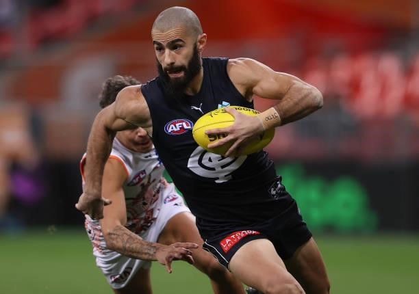 Adam Saad of the Blues breaks free of a tackle by Bobby Hill of the Giants during the round 14 AFL match between the Greater Western Sydney Giants...