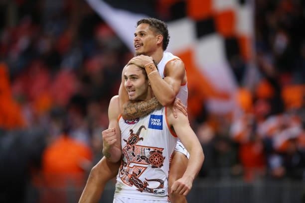 Jeremy Finlayson of the Giants celebrates kicking a goal with Bobby Hill of the Giants during the round 14 AFL match between the Greater Western...