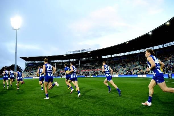 Kangaroos take the field during the round 14 AFL match between the North Melbourne Kangaroos and the Brisbane Lions at Blundstone Arena on June 19,...