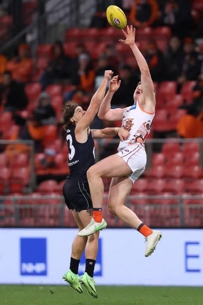 Tom Green of the Giants marks over Liam Stocker of the Blues during the round 14 AFL match between the Greater Western Sydney Giants and the Carlton...
