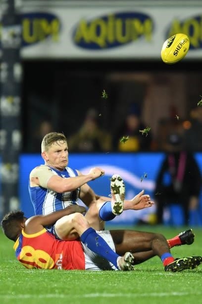 Jack Ziebell of the Kangaroos is tackled by Keidean Coleman of the Lions during the round 14 AFL match between the North Melbourne Kangaroos and the...