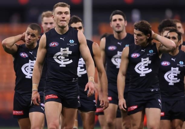 Patrick Cripps and his Blues team mates look dejected after losing the round 14 AFL match between the Greater Western Sydney Giants and the Carlton...