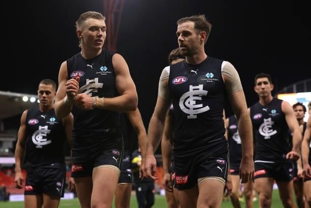 Patrick Cripps and Sam Docherty and their Blues team mates look dejected after losing the round 14 AFL match between the Greater Western Sydney...