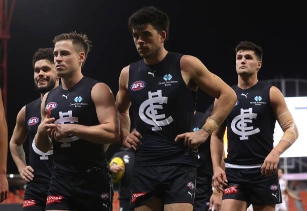 Matthew Kennedy and his Blues team mates look dejected after losing the round 14 AFL match between the Greater Western Sydney Giants and the Carlton...