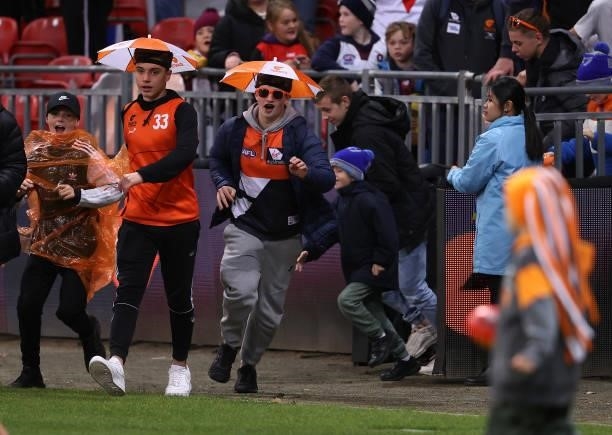 The crowd run on the field for kick to kick during the round 14 AFL match between the Greater Western Sydney Giants and the Carlton Blues at GIANTS...