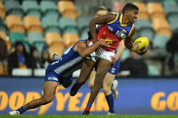 Keidean Coleman of the Lions is tackled during the round 14 AFL match between the North Melbourne Kangaroos and the Brisbane Lions at Blundstone...