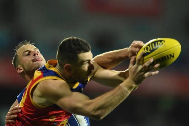 Josh Walker of the Kangaroos makes a tackle during the round 14 AFL match between the North Melbourne Kangaroos and the Brisbane Lions at Blundstone...