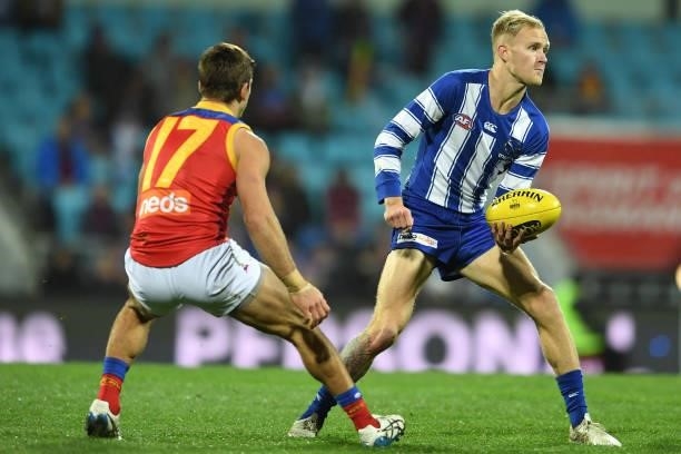 Jaidyn Stephenson of the Kangaroos handballs during the round 14 AFL match between the North Melbourne Kangaroos and the Brisbane Lions at Blundstone...