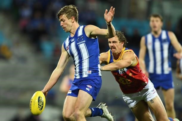 Trent Dumont of the Kangaroos is tackled by Joe Daniher of the Lions during the round 14 AFL match between the North Melbourne Kangaroos and the...