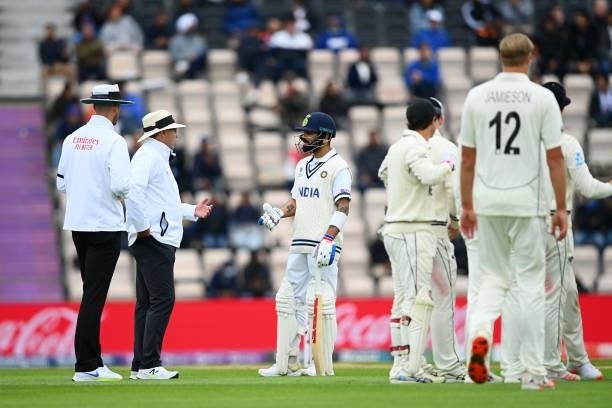 Virat Kohli of India talks to Umpires Richard Illingworth and Michael Gough after a Umpire review for his wicket during Day 2 of the ICC World Test...