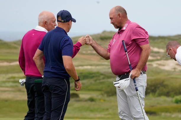 Thomas Bjorn of Denmark fist bumps others during the second round of the Farmfoods Legends European Links Championship hosted by Ian Woosnam at...