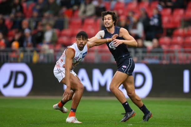 Connor Idun of the Giants and Jack Silvagni of the Blues compete for the ball during the round 14 AFL match between the Greater Western Sydney Giants...