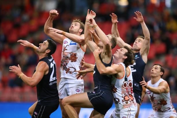 Players compete for the ball during the round 14 AFL match between the Greater Western Sydney Giants and the Carlton Blues at GIANTS Stadium on June...
