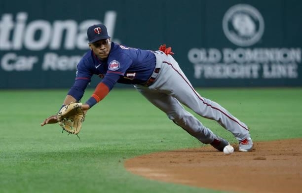 Jorge Polanco of the Minnesota Twins dives for a run scoring single off the bat of Nick Solak of the Texas Rangers during the first inning at Globe...