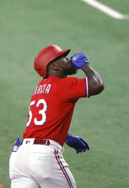 Adolis Garcia of the Texas Rangers reacts after hitting a solo home run against the Minnesota Twins during the seventh inning at Globe Life Field on...
