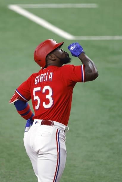 Adolis Garcia of the Texas Rangers reacts after hitting a solo home run against the Minnesota Twins during the seventh inning at Globe Life Field on...