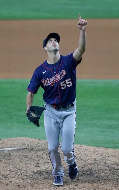 Taylor Rogers of the Minnesota Twins points at fly ball against the Texas Rangers during the eighth inning at Globe Life Field on June 18, 2021 in...
