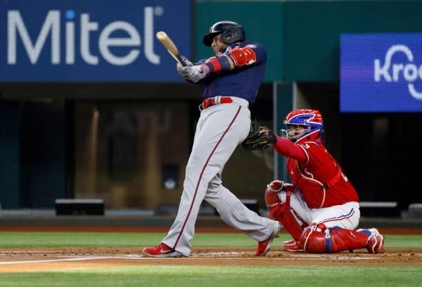 Nelson Cruz of the Minnesota Twins breaks his bat with a run scoring single against the Texas Rangers during the first inning at Globe Life Field on...