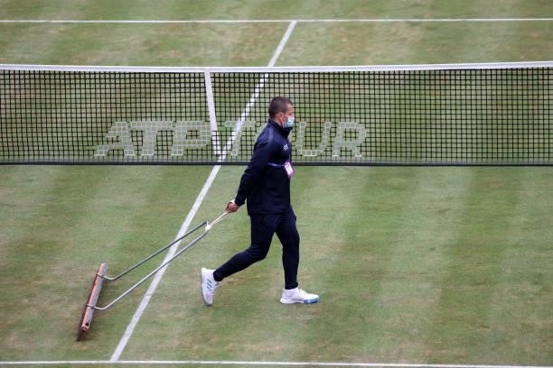 Ground staff prepare centre court after a light rain shower during Day 6 of The cinch Championships at The Queen's Club on June 19, 2021 in London,...