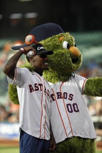Middleweight World Champion Jermall Charlo poses with Houston Astros mascot Orbit after throwing out the first pitch at Minute Maid Park on June 17,...