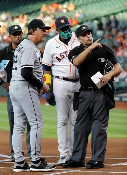 Umpire Mark Wegner goes over the ground rules with Tony La Russa of the Chicago White Sox and Dusty Baker Jr. #12 of the Houston Astros at Minute...