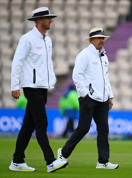 Umpires Richard Illingworth and Michael Gough walk off after an inspection as play is delayed ond Day 2 of the ICC World Test Championship Final...