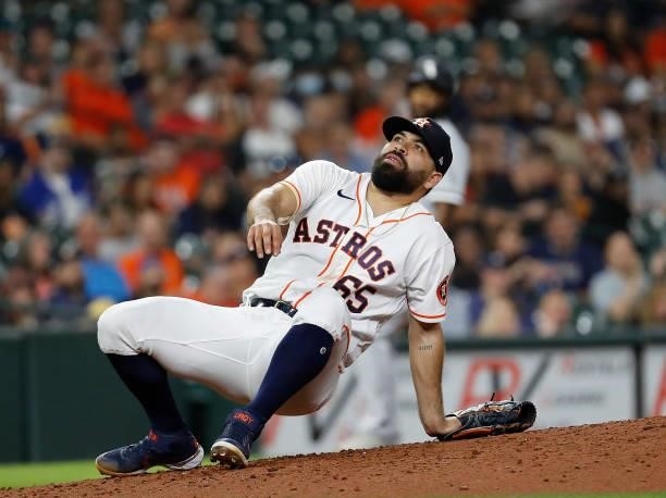 Jose Urquidy of the Houston Astros sits on the mound after being almost hit by a ball up the middle against the Chicago White Sox at Minute Maid Park...
