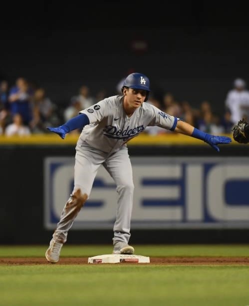 Andy Burns of the Los Angeles Dodgers celebrates after hitting a double against the Arizona Diamondbacks during the eighth inning at Chase Field on...