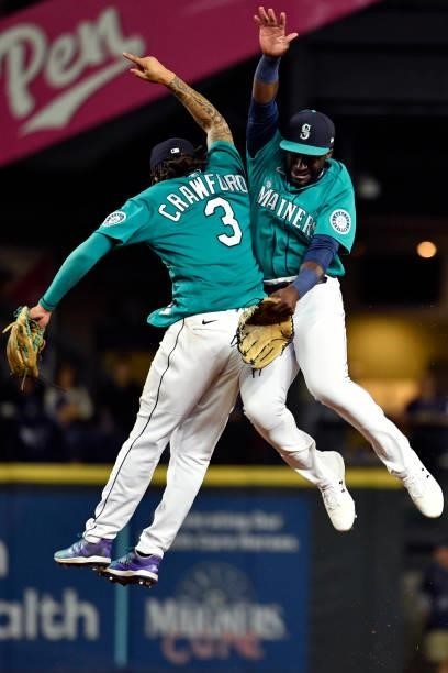 Crawford of the Seattle Mariners and Taylor Trammell of the Seattle Mariners leap in victory after the game against the Tampa Bay Rays at T-Mobile...
