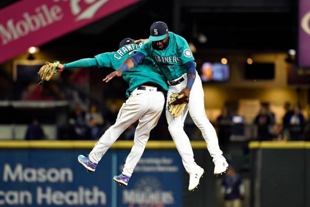 Crawford of the Seattle Mariners and Taylor Trammell of the Seattle Mariners leap in victory after the game against the Tampa Bay Rays at T-Mobile...