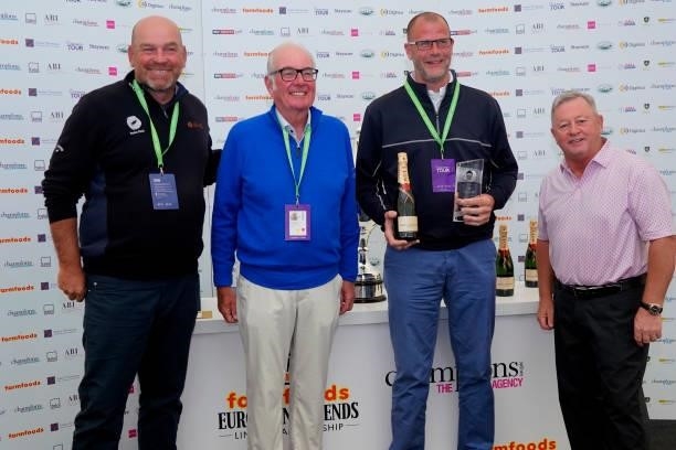 Thomas Bjorn of Denmark and his playing partner James Elston receives their winning prize from Eric Herd, CEO Farmfoods and Ian Woosnam after the...