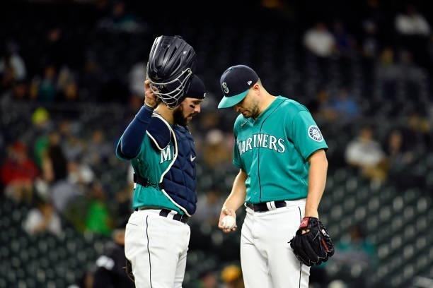 Luis Torrens talks with Kendall Graveman of the Seattle Mariners during the game against the Tampa Bay Rays at T-Mobile Park on June 18, 2021 in...