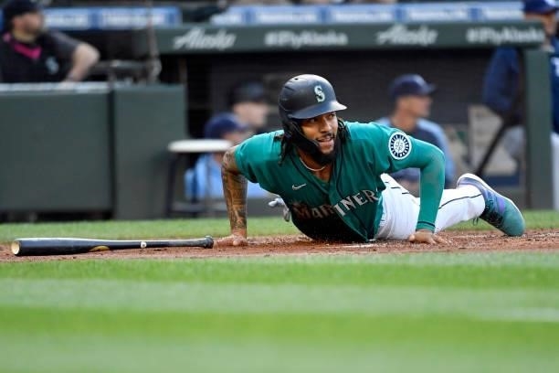 Crawford of the Seattle Mariners gets up after sliding for home during the game against the Tampa Bay Rays at T-Mobile Park on June 18, 2021 in...