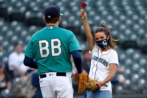 Katie Thurston of ABC's Bachelorette receives a rose from the Seattle Mariners ball boy before the game against the Tampa Bay Rays at T-Mobile Park...
